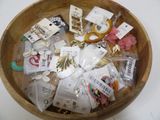 a wooden bowl filled with assorted items on a table