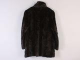 brown fur coat on a hanger against a white wall