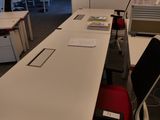 une longue table avec une chaise rouge au milieu de la pièce