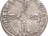 a close up of a coin with a cross on it