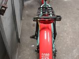 a red scooter parked in front of a building