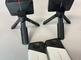 three cell phones and a remote control sitting on a table