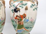 pair of asian vases with a woman holding a fan and a bird