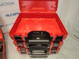 two red and black tool boxes sitting next to each other on a table