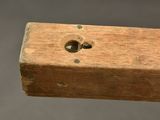 an old wooden box with a hole in the middle of it