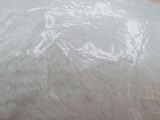 a bag of bread wrapped in plastic sitting on a counter