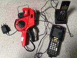 a cell phone, a cell phone, and a cord cutter on the floor