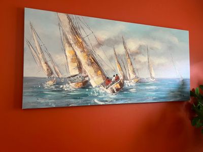 a painting on the wall of a room with a vase of flowers