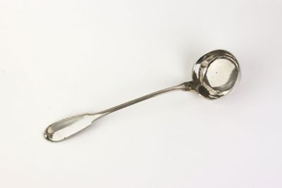 a silver spoon with a spoon handle on a white surface