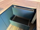 a blue cabinet with a metal drawer in it