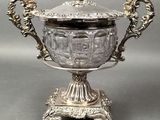 an antique silver plated bowl with a lid on a stand