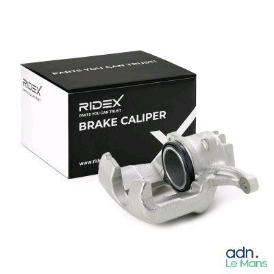a close up of a brake caliper in front of a box