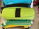 a lot of different colored bags on the table