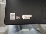 someone is holding a laptop with stickers on it in their hand