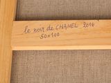 a close up of a wooden frame with writing on it
