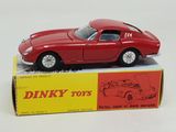 a red toy car sitting on top of a box