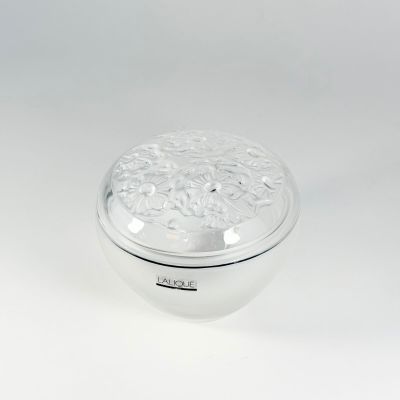 a silver box with a floral design on the lid