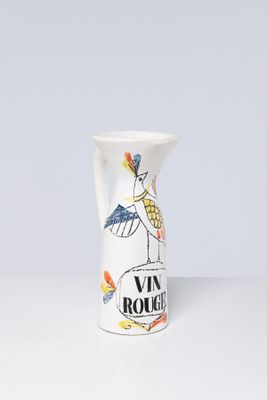 a white vase with a picture of a bird on it