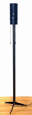 an image of a microphone on a stand on a wooden floor