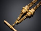 a pair of gold necklaces with a bar on a chain
