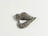 a close up of a silver brooch with crystals on it