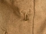 a close up of a jacket with a button on it