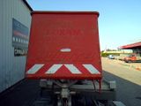 a red dump truck that is parked in front of a building
