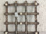 a picture of a wine rack made out of bamboo sticks