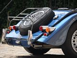 a blue car with a tire rack on the back of it
