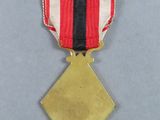 an image of a gold medal with a red, white and blue ribbon
