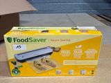 a box of food sitting on the floor next to a box of food