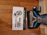 a vacuum that is sitting on the floor next to a box