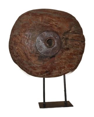 a large wooden object with a metal stand on a white background