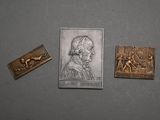 three different types of metal items including a stamp and a picture