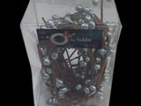 a clear box with a bunch of silver pearls in it