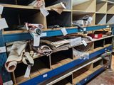 many different types of clothing on the shelves in the store