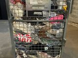 a metal cart with many items in it in a warehouse