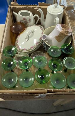 a box full of green glass items on a table