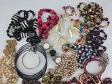 a close up of a pile of assorted jewelry on a table