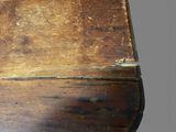 an old wooden box with a handle on top of it