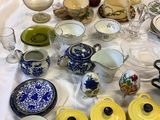 many different types of dishes and cups on the table
