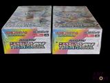 two boxes of pokemon trading cards on a black background