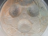a glass bowl with three balls in it on a table