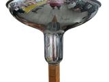 a silver plate with a wooden handle on a stand