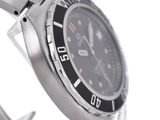 a close up of a watch on a metal bracelet