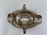 an antique silver plate with a handle on a white background