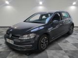 a grey volkswagen golf is parked on a checkered floor