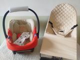 a baby seat and a baby car seat on a bed
