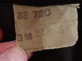 a close up of a person holding a label on a jacket