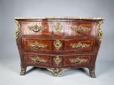 an antique chest of drawers with marble top and brass handles